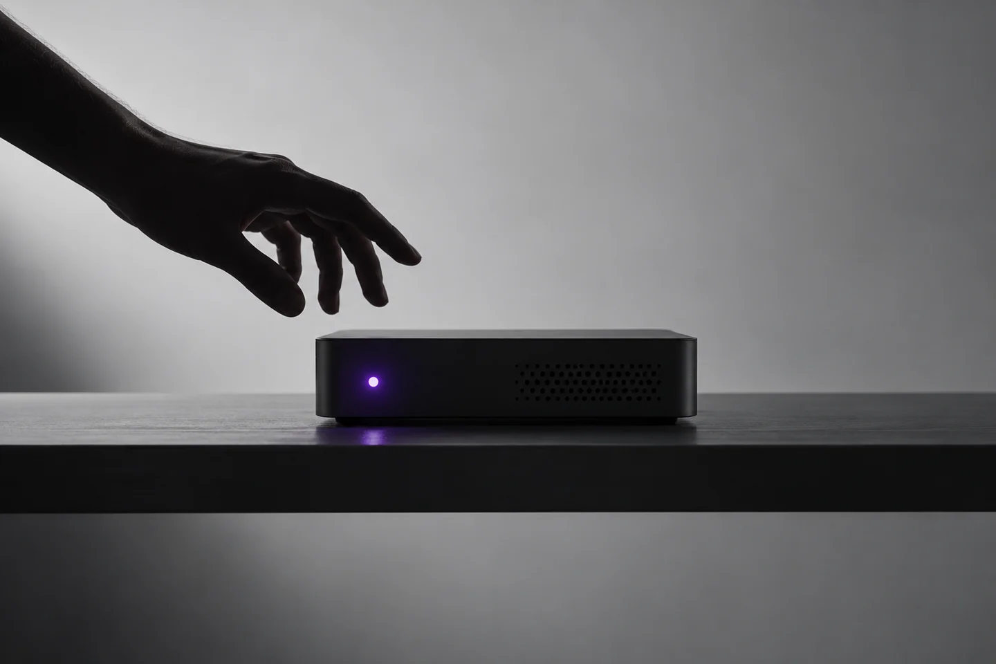 Concept image of a device emerging from deep shadows with purple light