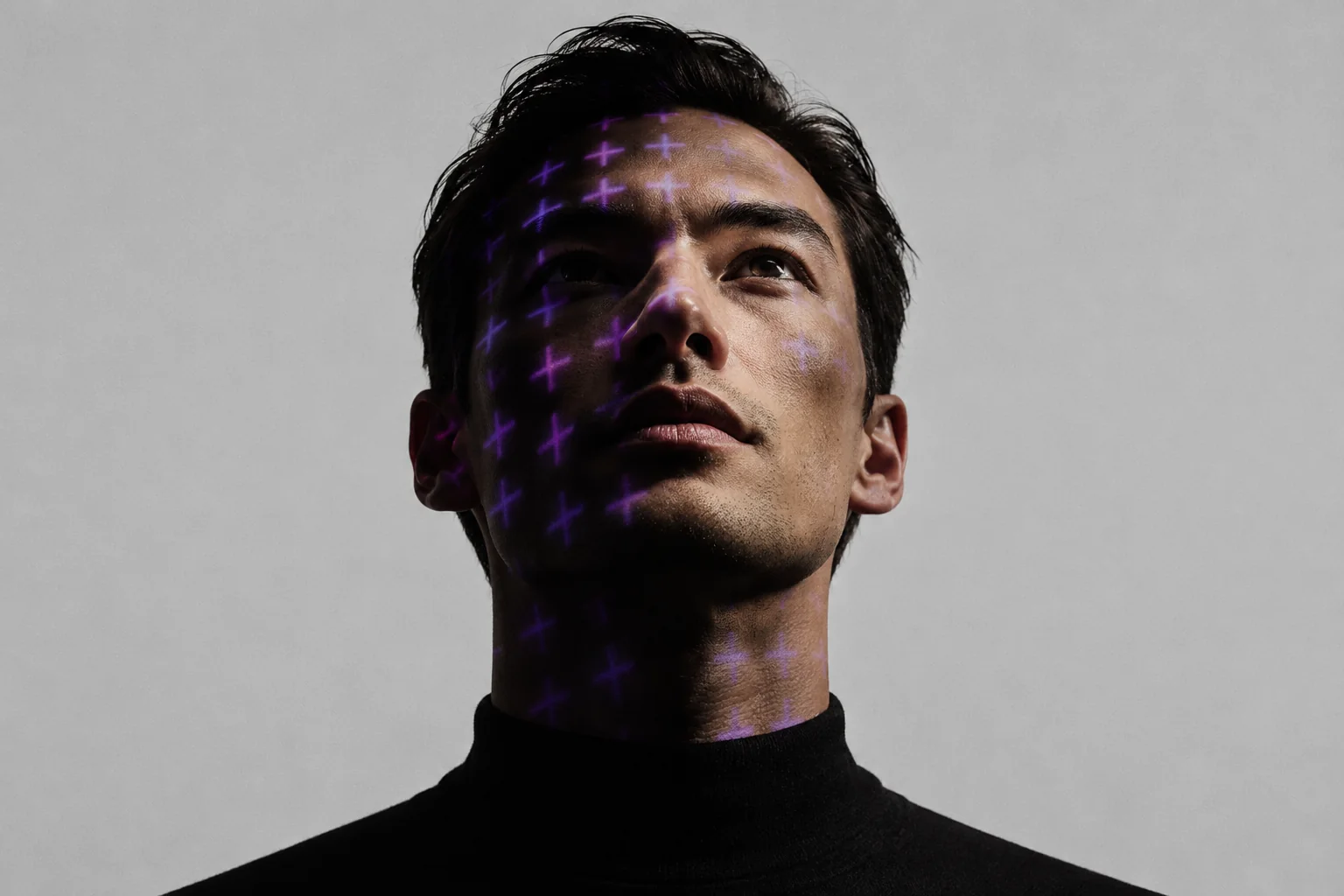 A portrait with a projected purple grid across the face, representing active risk assessment