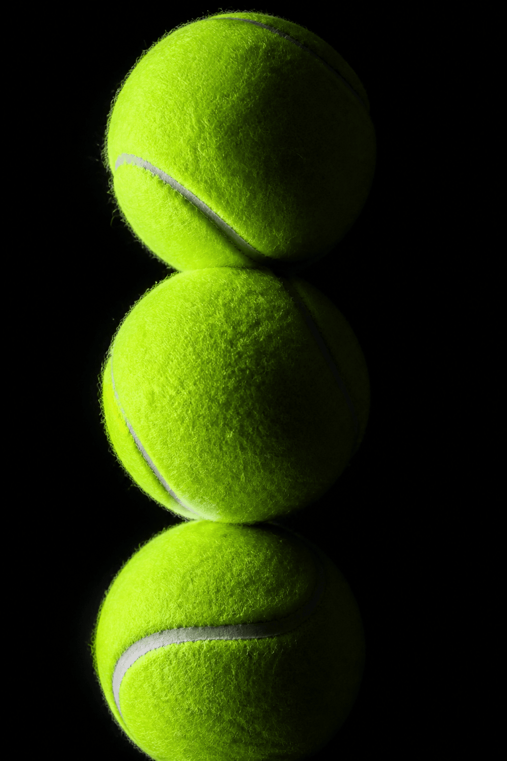 Stacked neon green tennis balls with dramatic studio lighting representing Luma Scenes storyboard-first AI video workflow