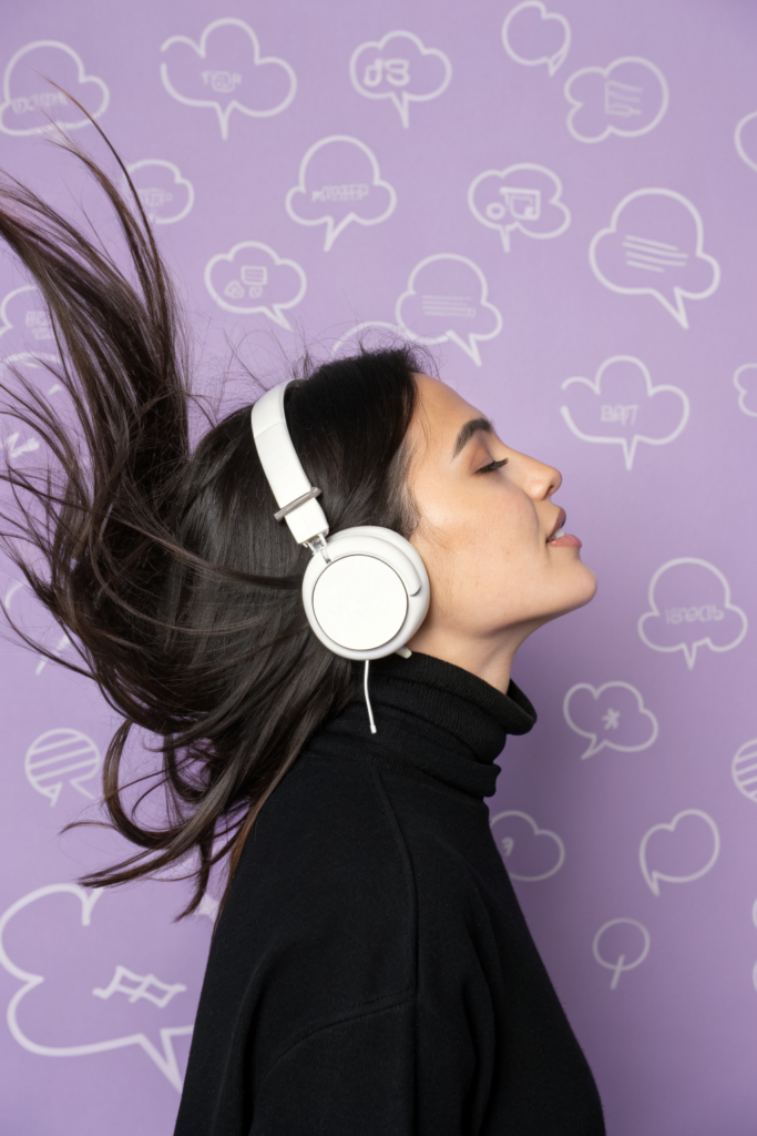 Profile of a person wearing oversized white headphones against a soft lavender background, atmospheric editorial portrait